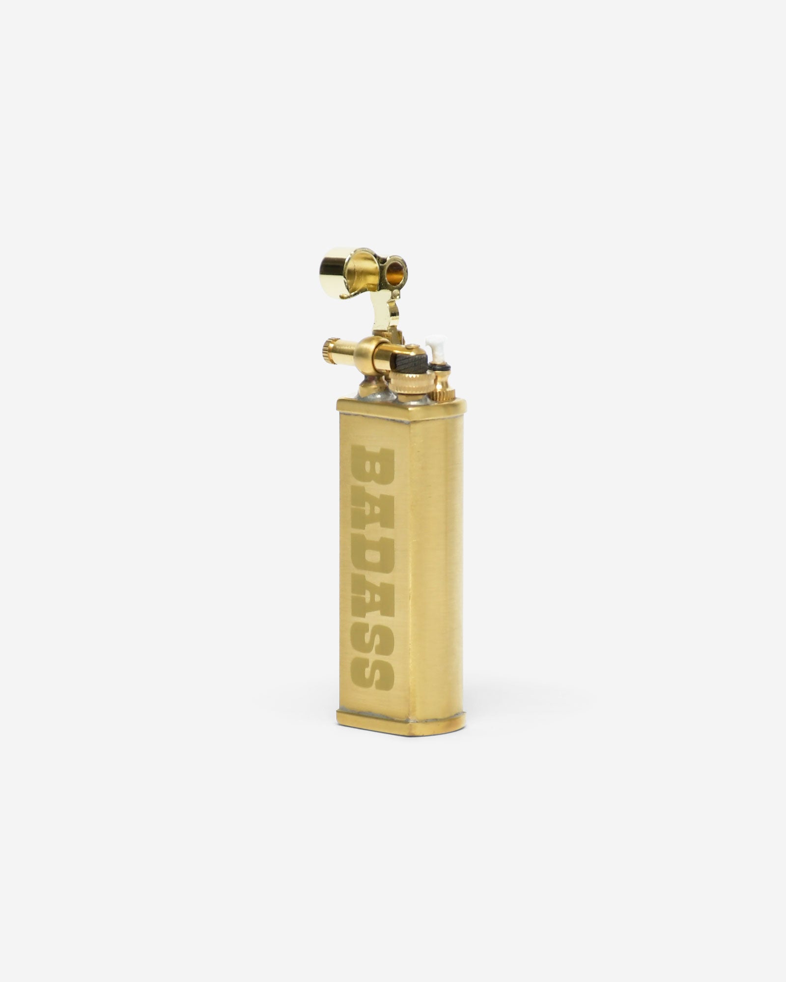 Brass lighter with 'BADASS' engraving on a white background